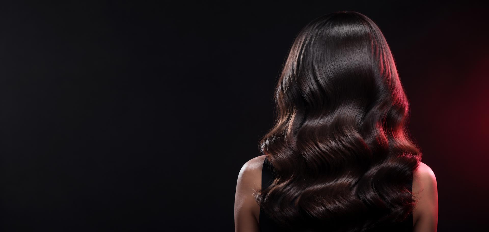 Glossy blowout viewed from behind under salon lighting